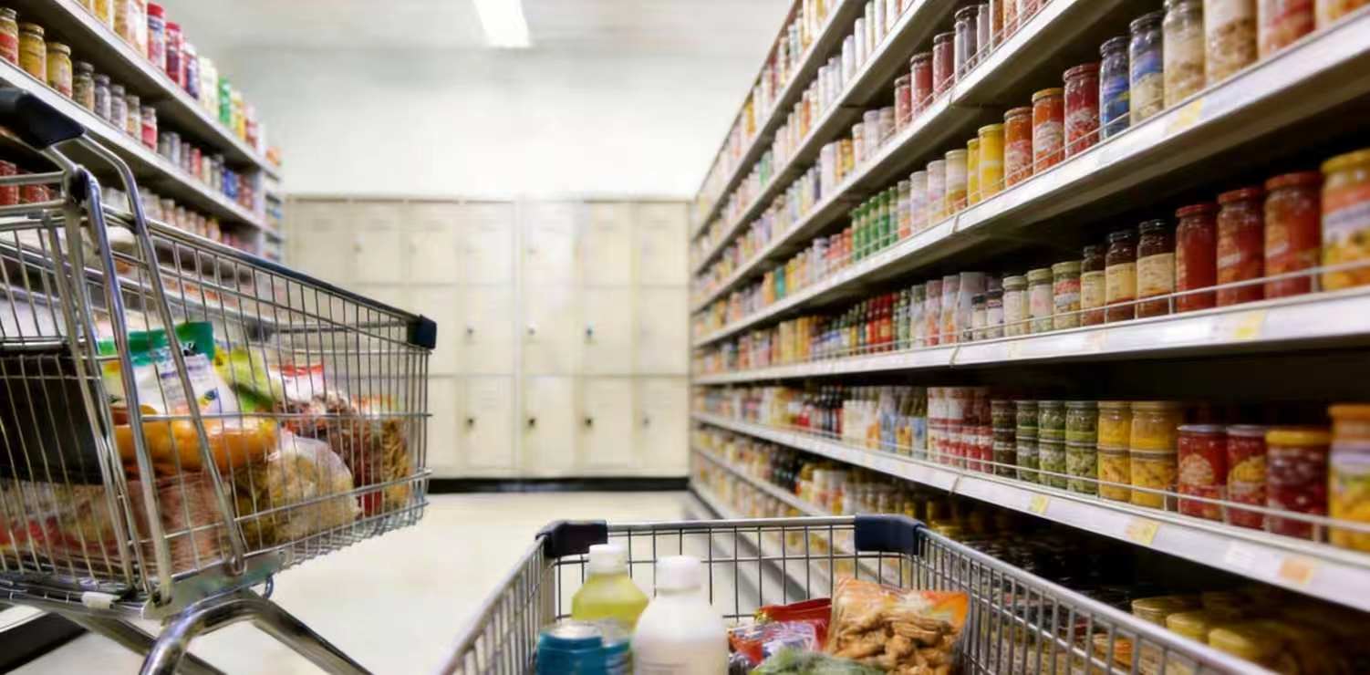 Supermarket aisle with shelving and shopping carts